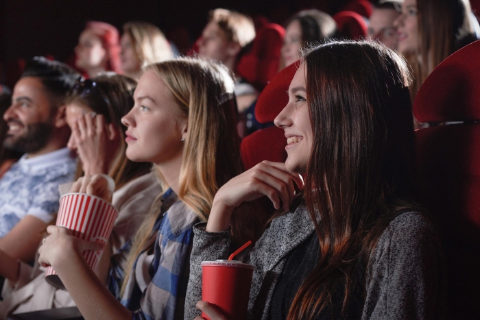 Group of girls laughing at the cinema
