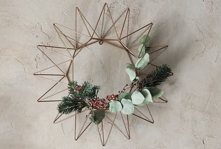 A budget-friendly, sustainable metal star wreath adorned with eucalyptus. 