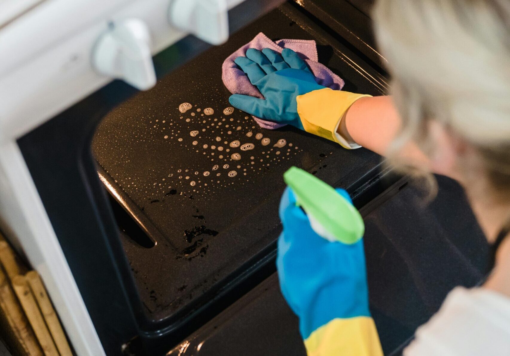 a person cleaning an oven
