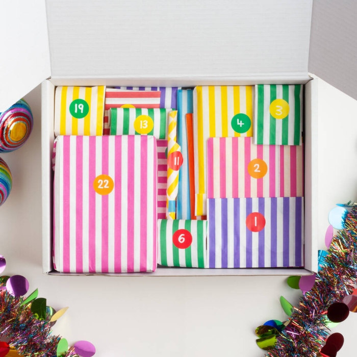 An open box containing the 24 gifts in the Colour Their Days stationery advent calendar