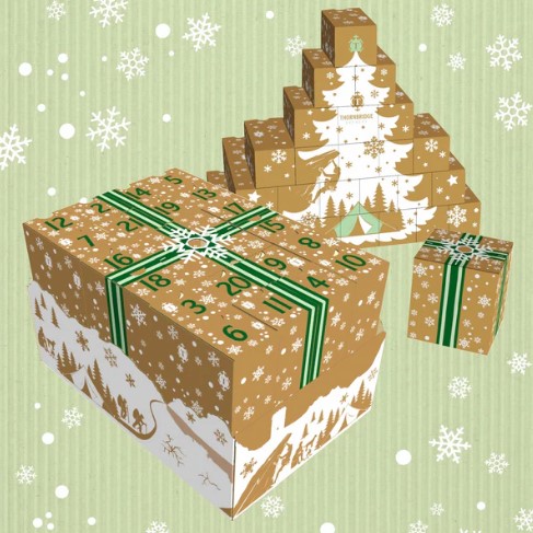 Three stacked advent calendar boxes with snowflakes and winter scenes on a green background.