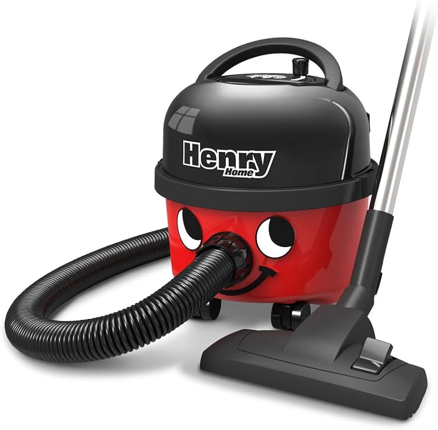 Red and black vacuum cleaner with eyes and a smiling face, featuring a flexible hose and a floor nozzle.