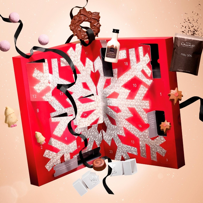 A red advent calendar surrounded by expensive chocolates for the Hotel Chocolat Grand Calendar