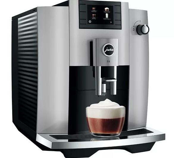 A silver and black coffee machine dispensing a foamy beverage into a glass mug.