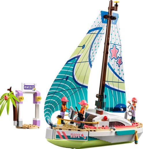 Toy sailboat with colorful sails, named "Hope," includes two mini-figures. Nearby is a small island with a palm tree and a purple-and-white arch marked "81x131x39.