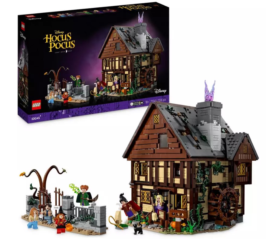 LEGO set of the Sanderson Sisters' cottage from Disney’s Hocus Pocus, featuring detailed house model and character mini-figures, with box packaging in the background.