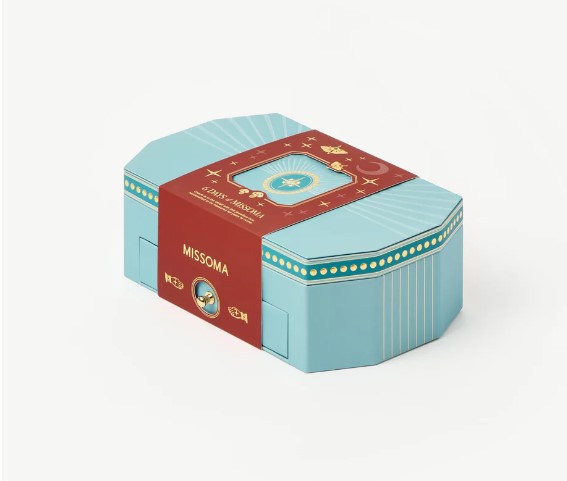 Turquoise and red decorative box with the brand name "Missoma" and vintage-style illustrations on the lid.