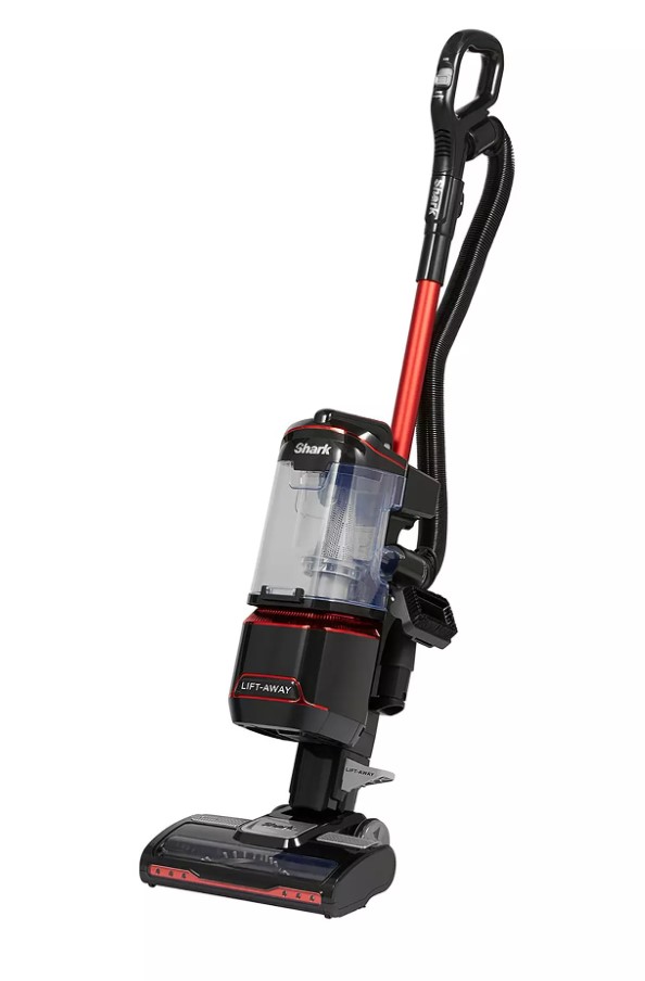 Upright vacuum cleaner with a red and black design, transparent dust canister, and hose attachment.