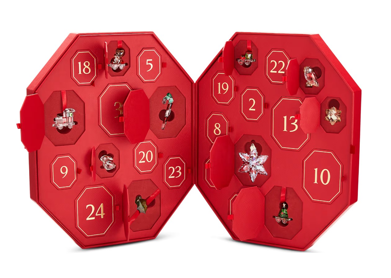 Red advent calendar with numbered doors, each revealing a jewelry piece.