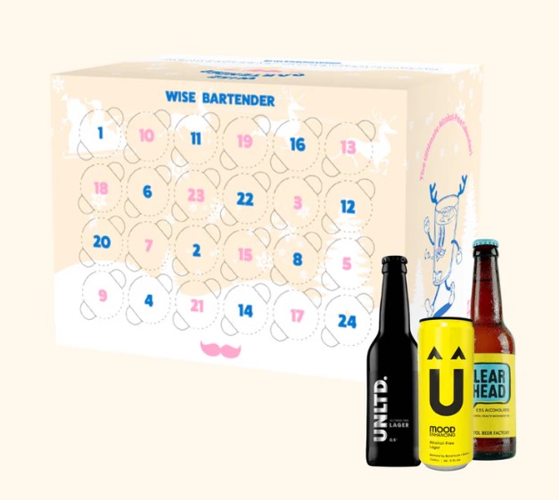 Advent calendar with numbered slots, accompanied by three assorted beer bottles.