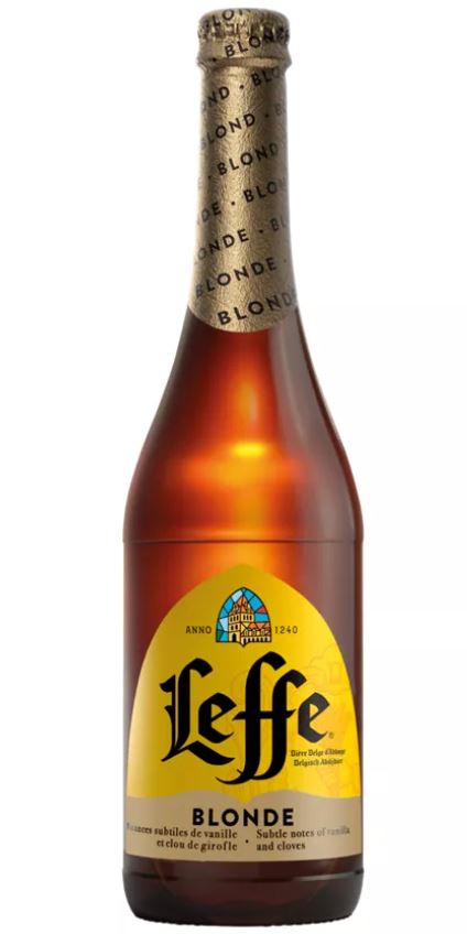 A bottle of Leffe Blonde beer with a yellow label and a patterned neck wrap. Text mentions subtle notes of vanilla and cloves.