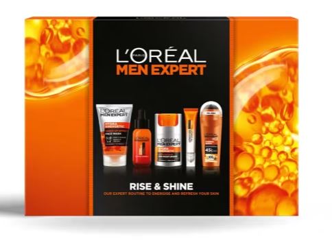 L'Oréal Men Expert "Rise & Shine" kit with skincare and grooming products in a black and orange box, featuring face wash, moisturizer, and deodorant.