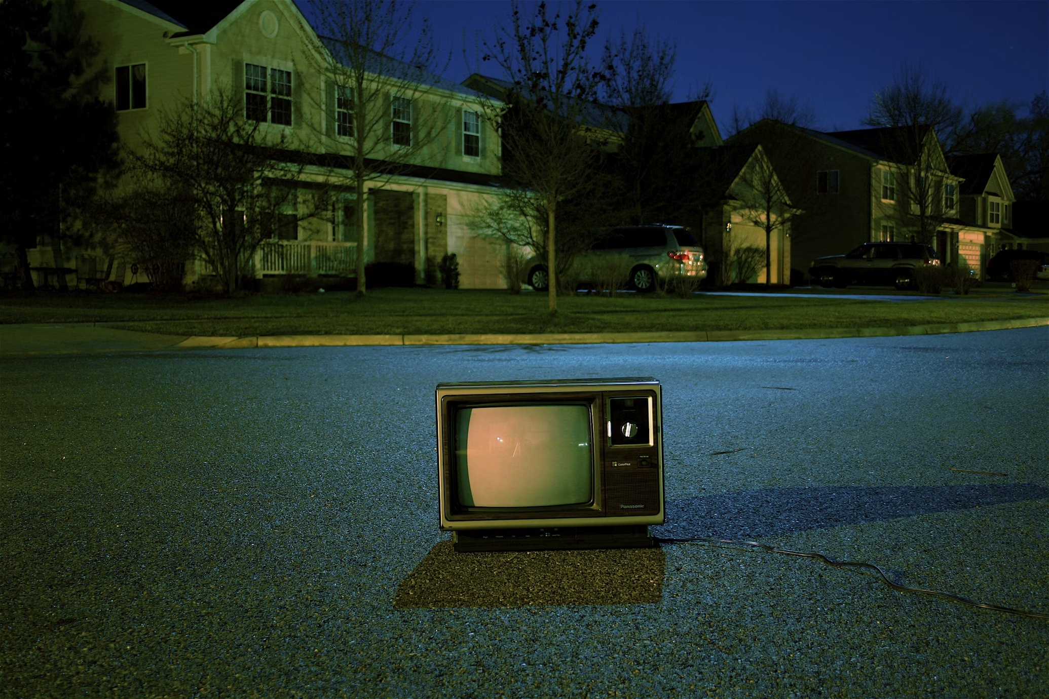 An image showing an old-school television in the middle of the road