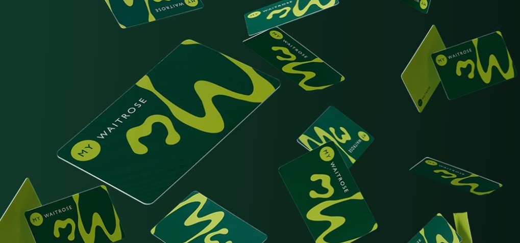 Floating green and yellow My Waitrose cards on a dark green background.