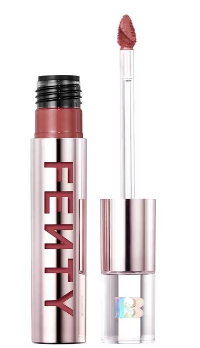 Lip gloss with a doe-foot applicator beside an open tube labeled "Fenty" in metallic lettering.