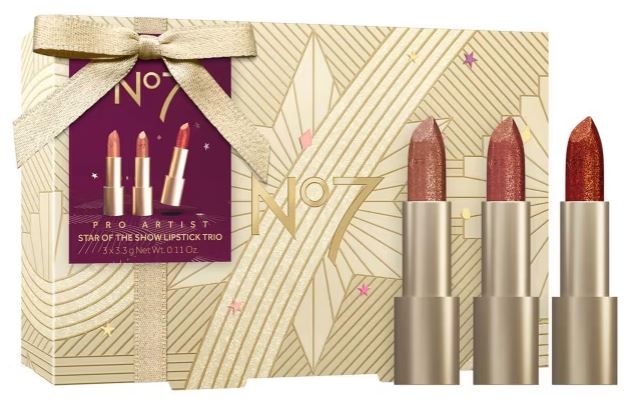 No7 Pro Artist Star of the Show Lipstick Trio. Features three lipsticks in pink, nude, and red shades, packaged in a gold patterned box with a ribbon.