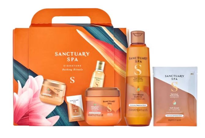 Sanctuary Spa gift set includes body wash, scrub, lotion, and oils in orange packaging with floral design.