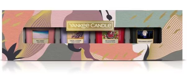 A Yankee Candle gift set box containing five candles: Pink Sands, Lemon Lavender, Red Raspberry, and two others, in a colorful abstract design packaging.