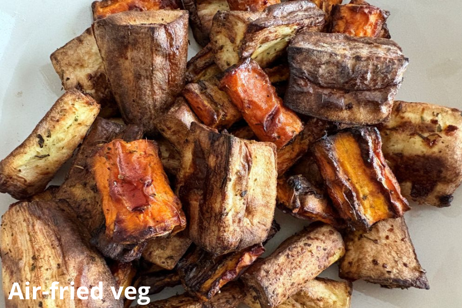 Air-fried vegetables including chunks of carrots and eggplant with a golden brown, crispy texture.