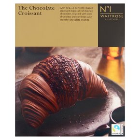 Box of "The Chocolate Croissant" from Waitrose, showing a croissant with chocolate drizzle and crumbs on a plate, branded packaging with Fairtrade logo.