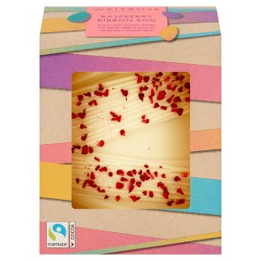 Box of Raspberry Ripple Ice Cream Cake with a clear window showing a swirl design topped with raspberry pieces. Packaging features colorful stripes and Fairtrade logo.